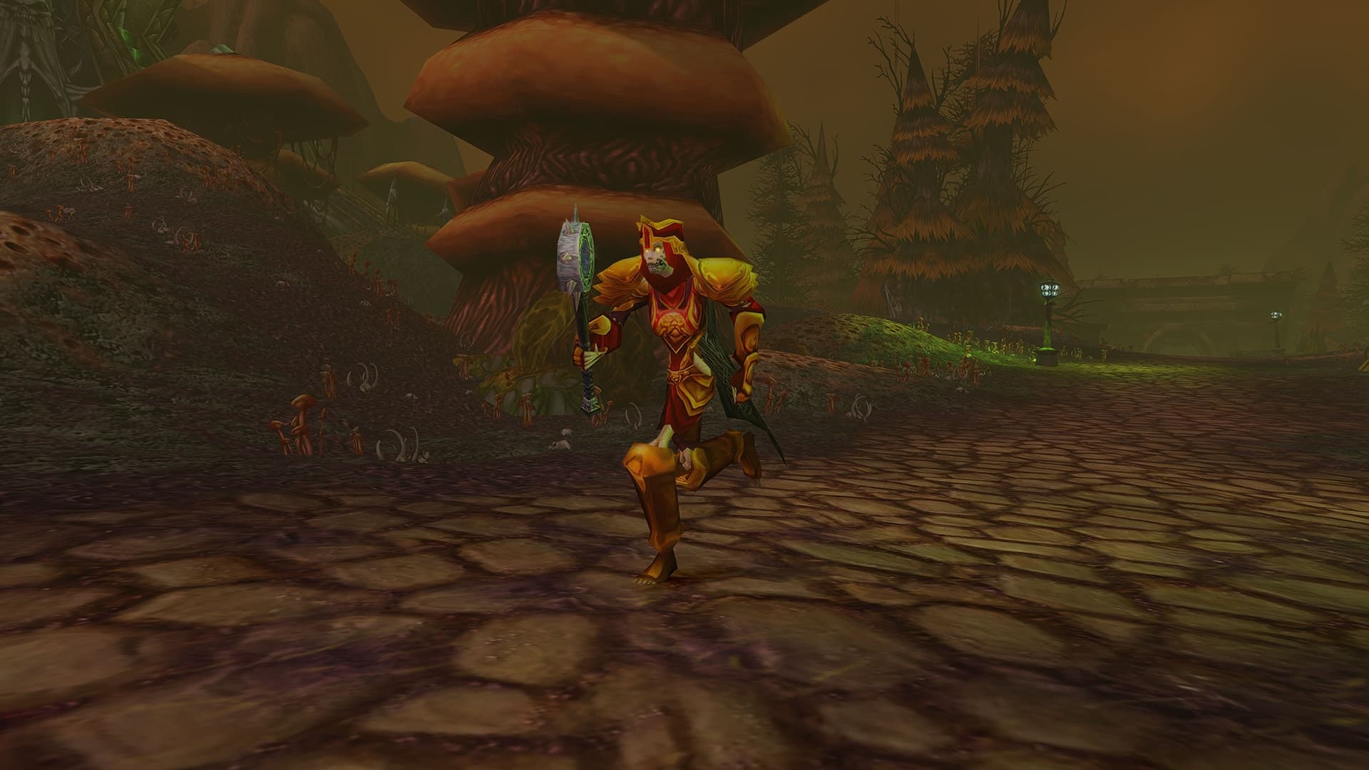 A Paladin in gold and red armor carries a shield and weapon along a forest path in Blizzard's Forever preview.