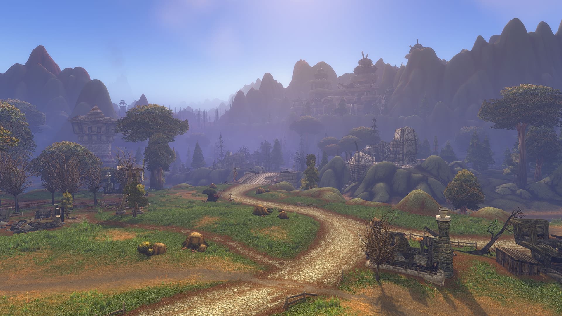 Warm daylight and distant haze illuminate a road, ruined walls, and hills in Blizzard's Forever environmental preview.